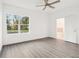 Bright bedroom with wood floors and a large window; ensuite bath accessible through open door at 1856 9Th Ave, Deland, FL 32724
