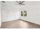Bright bedroom with a large window, ceiling fan, and light wood flooring at 1856 9Th Ave, Deland, FL 32724