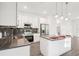 Close-up of the modern kitchen with stainless steel appliances, an island, and chic backsplash at 1856 9Th Ave, Deland, FL 32724
