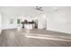 Open-concept living space with hardwood floors flowing into a modern kitchen with stainless steel appliances at 1856 9Th Ave, Deland, FL 32724