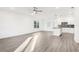 Bright and airy living room with light hardwood flooring and a view into a well-lit, modern kitchen at 1856 9Th Ave, Deland, FL 32724