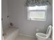 Functional bathroom with tiled floors, toilet, and bench at 2051 Sherwood Forest Dr, Orange City, FL 32763
