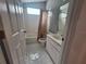 Bathroom featuring tile flooring, white cabinets and a tub at 2051 Sherwood Forest Dr, Orange City, FL 32763