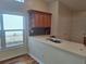 Bright kitchen with tiled floors, light colored cabinets, and a view to the outdoors at 2051 Sherwood Forest Dr, Orange City, FL 32763