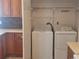 Functional laundry room with cabinets, washer, dryer, and modern countertop at 2051 Sherwood Forest Dr, Orange City, FL 32763