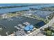 Aerial view featuring waterfront property with a large marina, boats, and nearby commercial buildings at 208 Wall St # 204, Daytona Beach, FL 32114