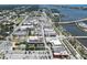 Aerial view of a cityscape showcasing buildings, roads, and waterway with boats and docks in the distance at 208 Wall St # 204, Daytona Beach, FL 32114