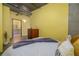 Comfortable bedroom with bright yellow walls at 208 Wall St # 204, Daytona Beach, FL 32114
