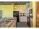Bright kitchen with a breakfast bar, black appliances, and under-cabinet lighting at 208 Wall St # 204, Daytona Beach, FL 32114