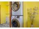 Updated laundry room features modern, front load, stacked washer and dryer at 208 Wall St # 204, Daytona Beach, FL 32114