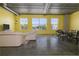 Open-concept living room with a dining area, natural light, and exposed ducts at 208 Wall St # 204, Daytona Beach, FL 32114