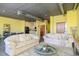 Comfortable living room with sofas, glass coffee table, and open kitchen access at 208 Wall St # 204, Daytona Beach, FL 32114