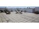 Open-air rooftop patio with dining table and seating, ideal for enjoying city views and sunshine at 208 Wall St # 204, Daytona Beach, FL 32114