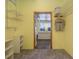 Walk in closet with custom storage, washer and dryer and a view into living room at 208 Wall St # 204, Daytona Beach, FL 32114