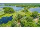 Beautiful aerial view of a lakeside home surrounded by lush greenery and serene waterways at 2163 Fireside Rd, Deltona, FL 32738