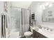 Cozy bathroom featuring a marble-look tub surround, updated vanity and decorative shelving at 2163 Fireside Rd, Deltona, FL 32738
