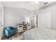 Bright bedroom with a comfortable bed, blue accent chair, and a decorative cabinet at 2163 Fireside Rd, Deltona, FL 32738