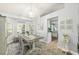 Charming dining area featuring a rustic table, chandelier, and large windows offering ample natural light and views at 2163 Fireside Rd, Deltona, FL 32738