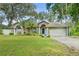 Charming single-story home with well-manicured lawn, mature trees, and a two-car garage in a serene neighborhood at 2163 Fireside Rd, Deltona, FL 32738