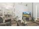 Cozy living room with stylish decor, wood floors, and a view into the dining area, perfect for modern living at 2163 Fireside Rd, Deltona, FL 32738