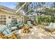 Screened patio with an array of cushioned seating, a table, and outdoor plants at 2163 Fireside Rd, Deltona, FL 32738