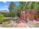 The backyard features red sheds, a small bench, a lamp, and a red brick pathway at 2478 Unionville Dr, Deltona, FL 32725