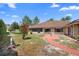 Spacious backyard featuring a red brick walkway and well-maintained landscaping at 2478 Unionville Dr, Deltona, FL 32725