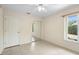 Bedroom featuring sliding closet doors, a window, and tile flooring at 2478 Unionville Dr, Deltona, FL 32725