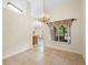 Dining room showcasing tile flooring, a chandelier, and views to the exterior at 2478 Unionville Dr, Deltona, FL 32725