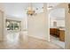 Dining room with ceramic tile, chandelier, and an archway to the kitchen at 2478 Unionville Dr, Deltona, FL 32725