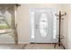 Foyer features decorative window and sidelights, tile flooring and coat rack at 2478 Unionville Dr, Deltona, FL 32725