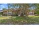 Charming single-story brick home featuring a well-manicured lawn and mature landscaping at 2478 Unionville Dr, Deltona, FL 32725