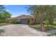 Home exterior featuring a long driveway and well-maintained landscaping at 2478 Unionville Dr, Deltona, FL 32725