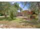 Brick home with a well manicured lawn, palm trees, and flowering shrubs at 2478 Unionville Dr, Deltona, FL 32725