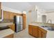 Modern kitchen with stainless steel refrigerator, tile backsplash, and wooden cabinets at 2478 Unionville Dr, Deltona, FL 32725