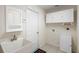Laundry area with a sink, cabinets, and tile flooring at 2478 Unionville Dr, Deltona, FL 32725