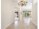 Open-concept living area with tile floors, chandelier, and arched doorway at 2478 Unionville Dr, Deltona, FL 32725