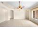 Bright living room featuring tile flooring, a ceiling fan, and arched doorways for an open feel at 2478 Unionville Dr, Deltona, FL 32725