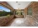 Enclosed brick patio with large windows and a ceiling fan at 2478 Unionville Dr, Deltona, FL 32725