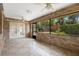 Enclosed brick patio with large windows and a ceiling fan at 2478 Unionville Dr, Deltona, FL 32725