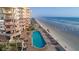 Breathtaking aerial view of a condo with a large pool, sundeck, and ocean views at 2515 S Atlantic Ave # 203, Daytona Beach, FL 32118