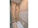 Bathroom shower-tub combo featuring tan tile surround and grab bar at 2515 S Atlantic Ave # 203, Daytona Beach, FL 32118