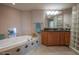 Bright bathroom features a soaking tub with tile surround and a vanity with cabinets at 2515 S Atlantic Ave # 203, Daytona Beach, FL 32118