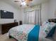 Bedroom features a ceiling fan, television, dresser, and decorative valance at 2515 S Atlantic Ave # 203, Daytona Beach, FL 32118