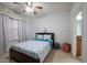 Comfortable bedroom with coastal decor, a ceiling fan, a full-sized bed, and an ensuite bathroom at 2515 S Atlantic Ave # 203, Daytona Beach, FL 32118