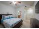 Bedroom features a ceiling fan, television, dresser, and decorative valance at 2515 S Atlantic Ave # 203, Daytona Beach, FL 32118