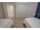Cozy bedroom with two beds, plush carpeting, and closet for storage at 2515 S Atlantic Ave # 203, Daytona Beach, FL 32118