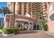 Elegant covered entrance with brick columns, arched windows, and lush landscaping at 2515 S Atlantic Ave # 203, Daytona Beach, FL 32118