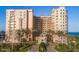 Elegant multi-story condominium featuring manicured landscaping and a circular driveway at 2515 S Atlantic Ave # 203, Daytona Beach, FL 32118
