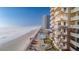 Exterior view of condo with balconies overlooking the ocean, pool, and sandy beach at 2515 S Atlantic Ave # 203, Daytona Beach, FL 32118